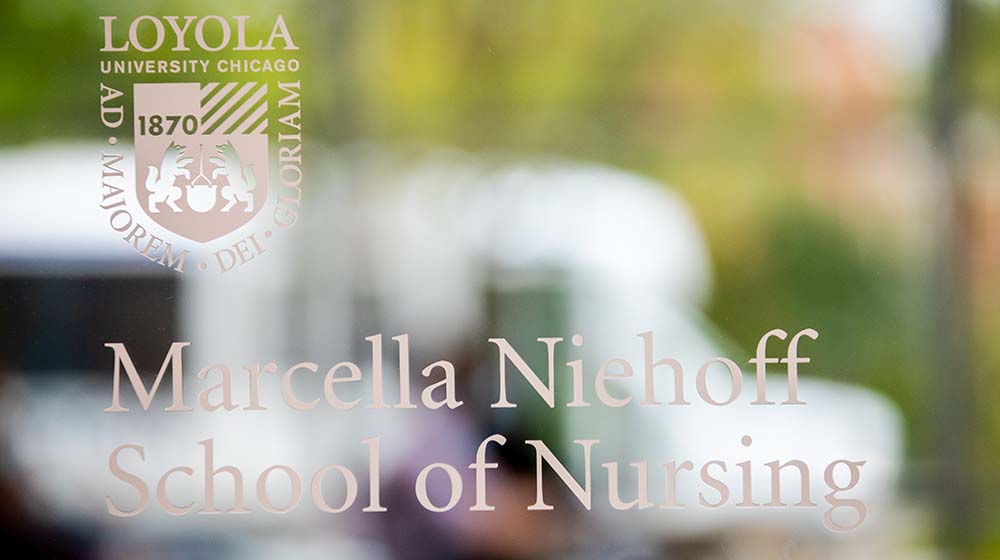 The Marcella Niehoff School of Nursing name displayed on a clear glass door at the Health Sciences Campus